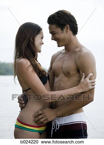 Stock Image - young couple at the beach. Fotosearch