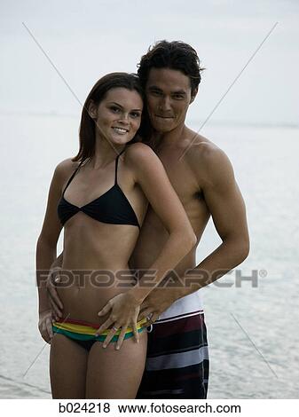 young couple at the beach View Large Photo Image Stock Photo - young couple at the beach. Fotosearch