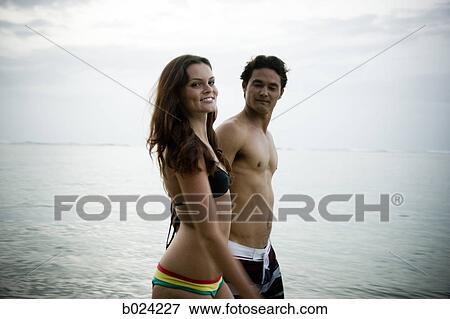 Stock Photo - young couple at the beach. Fotosearch