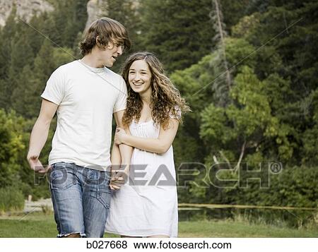 Stock Photo - young couple by a pond. Fotosearch