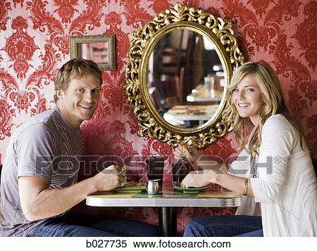 young couple eating together at a diner View Large Photo Image Stock Photography - young couple eating together at a diner. Fotosearch