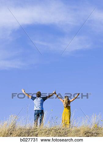 young couple holding hands on a ridge View Large Photo Image Stock Image - young couple holding hands on a ridge. Fotosearch