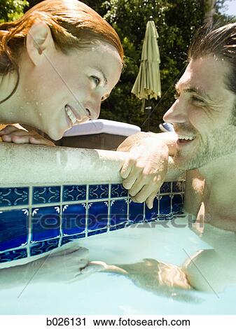 young couple in a swimming pool View Large Photo Image Stock Image - young couple in a swimming pool. Fotosearch