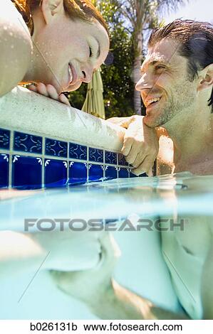 young couple in a swimming pool View Large Photo Image Stock Image - young couple in a swimming pool. Fotosearch