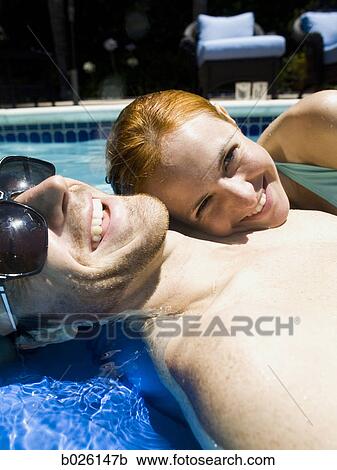 young couple in a swimming pool View Large Photo Image Stock Image - young couple in a swimming pool. Fotosearch