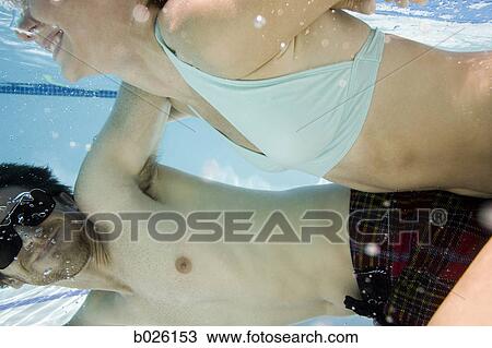 young couple in a swimming pool View Large Photo Image Stock Image - young couple in a swimming pool. Fotosearch