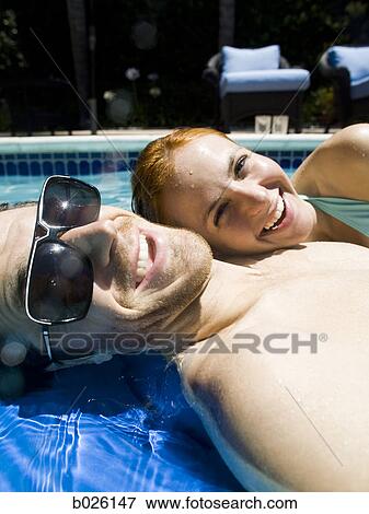 young couple in a swimming pool View Large Photo Image Stock Photo - young couple in a swimming pool. Fotosearch