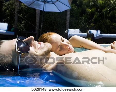 young couple in a swimming pool View Large Photo Image Stock Photo - young couple in a swimming pool. Fotosearch