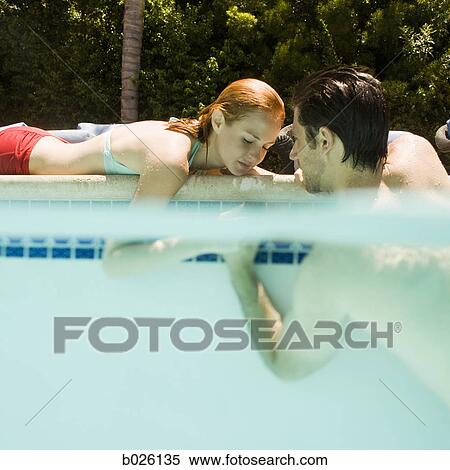 young couple in a swimming pool View Large Photo Image Stock Photography - young couple in a swimming pool. Fotosearch