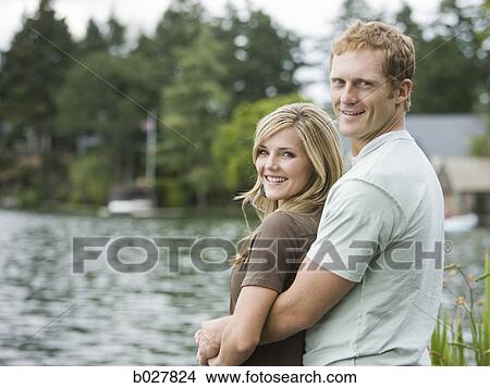 young couple in front of a lake View Large Photo Image Picture - young couple in front of a lake. Fotosearch