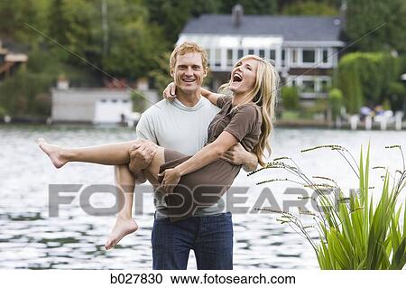 young couple in front of a lake View Large Photo Image Stock Image - young couple in front of a lake. Fotosearch