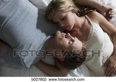 young couple lying on the bed View Large Photo Image Stock Image - young couple lying on the bed. Fotosearch
