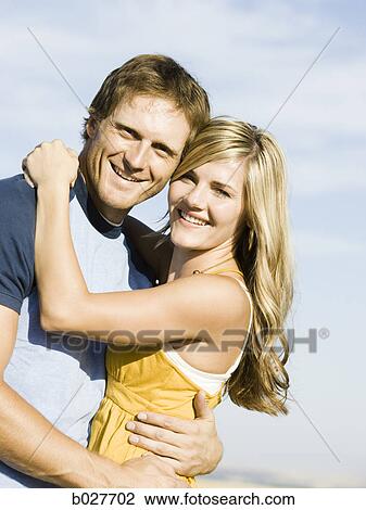 Stock Image - young couple on the side of the road. Fotosearch