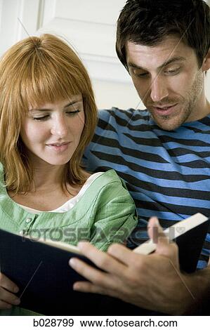 young couple reading a book together View Large Photo Image Stock Photo - young couple reading a book together. Fotosearch