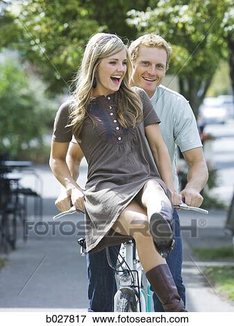 young couple riding a bike View Large Photo Image Stock Photo - young couple riding a bike. Fotosearch