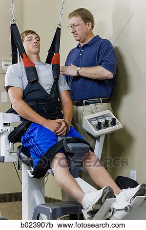 Stock Image - young man in a suspension harness. Fotosearch