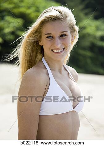 Stock Photo - young woman at the beach. Fotosearch