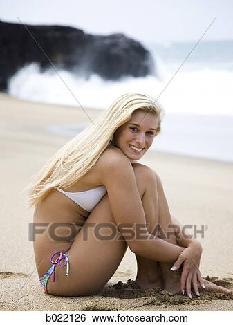 Stock Photograph - young woman at the beach. Fotosearch