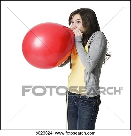 young woman blowing up a balloon View Large Photo Image Picture - young woman blowing up a balloon. Fotosearch