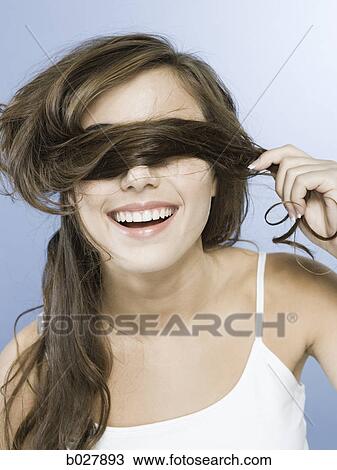 young woman covering eyes with her hair View Large Photo Image Stock Image - young woman covering eyes with her hair. Fotosearch