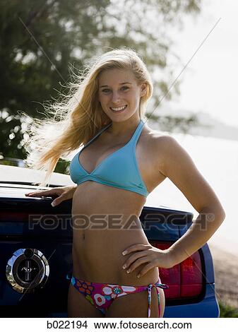 young woman in a bikini with a convertible View Large Photo Image Picture - young woman in a bikini with a convertible. Fotosearch