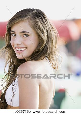 Stock Image - young woman in a white swimsuit. Fotosearch