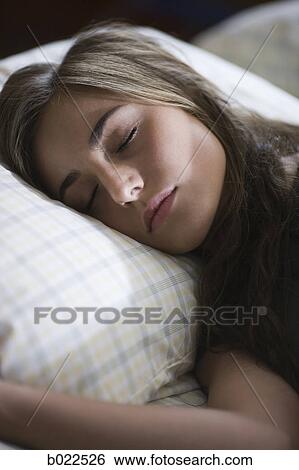 Stock Photograph - young woman in bed. Fotosearch