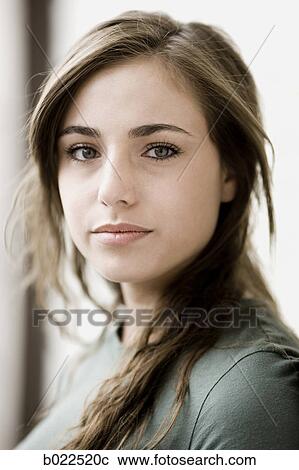 Stock Image - young woman looking at camera. Fotosearch