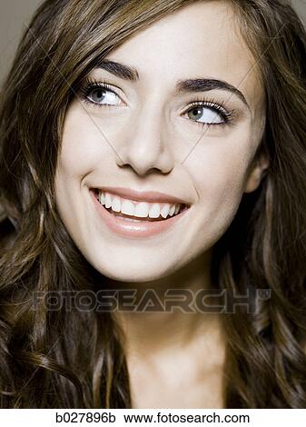 Stock Image - young woman looking up. Fotosearch