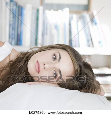 young woman lying on her bed View Large Photo Image Stock Image - young woman lying on her bed. Fotosearch
