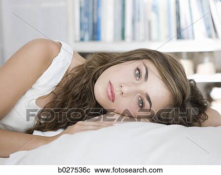 young woman lying on her bed View Large Photo Image Stock Image - young woman lying on her bed. Fotosearch
