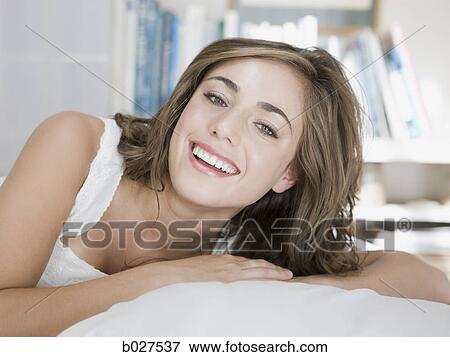young woman lying on her bed View Large Photo Image Stock Photo - young woman lying on her bed. Fotosearch
