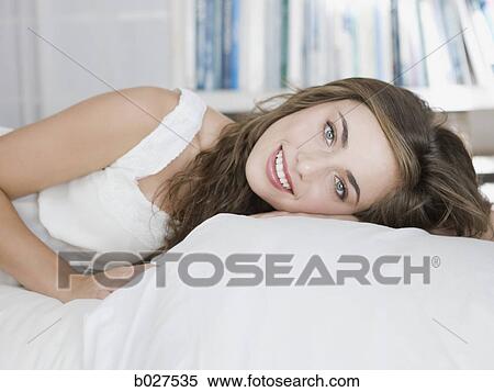 young woman lying on her bed View Large Photo Image Stock Photography - young woman lying on her bed. Fotosearch