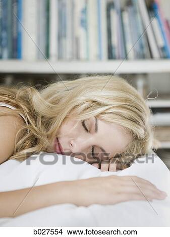 young woman lying on the bed in her bedroom View Large Photo Image Picture - young woman lying on the bed in her bedroom. Fotosearch