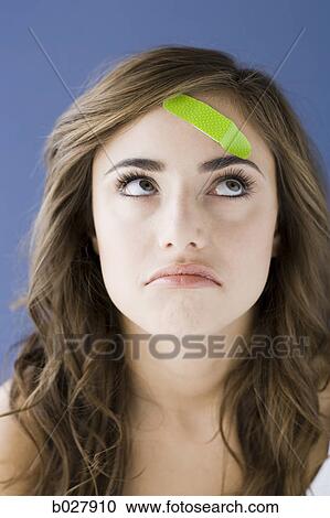 young woman with a bandaid on her forehead View Large Photo Image Stock Image - young woman with a bandaid on her forehead. Fotosearch