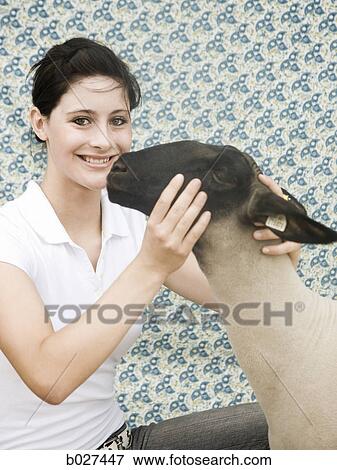 Stock Photo - young woman with a sheep. Fotosearch