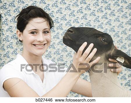 Stock Photograph - young woman with a sheep. Fotosearch