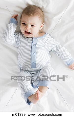baby boy lying on a bed View Large Photo Image Stock Photo - baby boy lying on a bed. Fotosearch