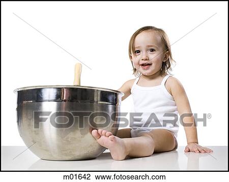 Stock Image - baby girl and a mixing bowl. Fotosearch