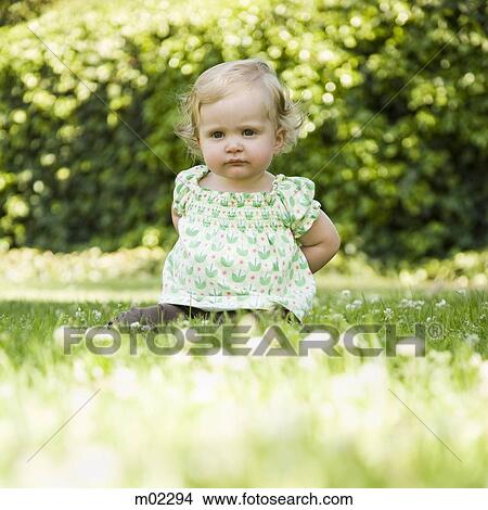 Picture - baby girl on the grass. Fotosearch