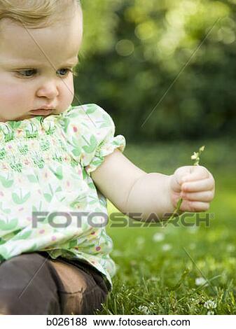 Stock Photo - baby girl on the grass. Fotosearch