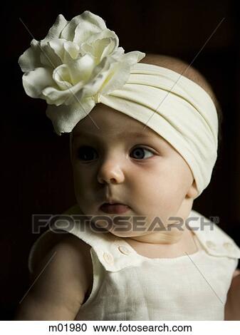 Stock Image - baby girl with a bow on her head. Fotosearch
