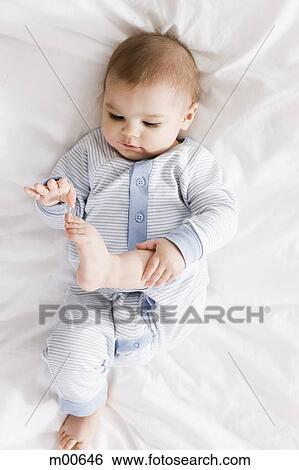 Stock Photograph - baby on a bed. Fotosearch