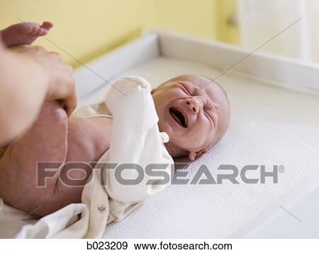 Stock Photo - baby on a changing table. Fotosearch