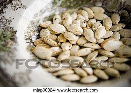 bowl of pumpkin seeds View Large Photo Image Picture - bowl of pumpkin seeds. Fotosearch