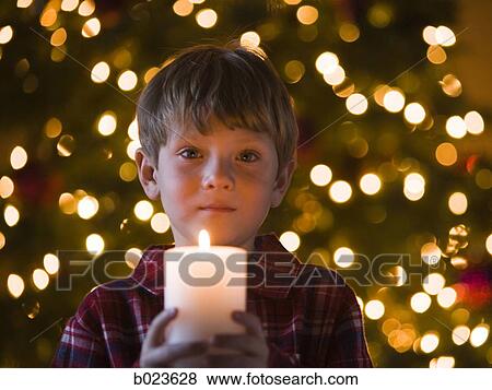 boy at christmas holding a candle View Large Photo Image Stock Photo - boy at christmas holding a candle. Fotosearch