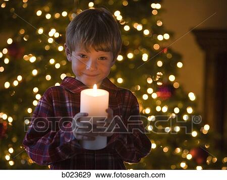 boy at christmas holding a candle View Large Photo Image Stock Photo - boy at christmas holding a candle. Fotosearch