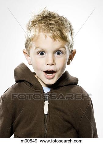 Stock Photo - boy looking at the camera in disebelief. Fotosearch