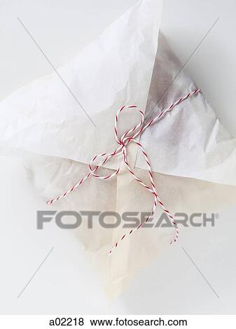 Bread wrapped in paper and tied up with string, view from above View Large Photo Image Stock Photo - Bread wrapped in paper and tied up with string, view from above. Fotosearch