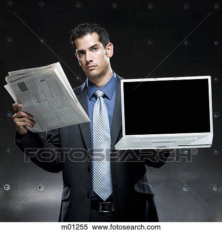 businessman holding a newspaper and a laptop View Large Photo Image Stock Photography - businessman holding a newspaper and a laptop. Fotosearch